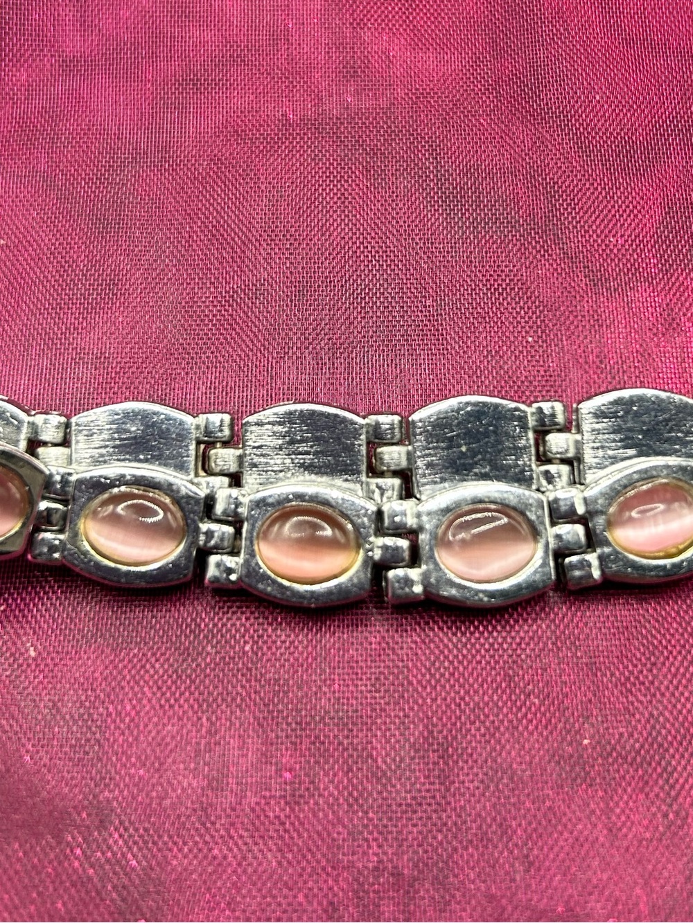 97- pink cat eye silver tone bracelet
